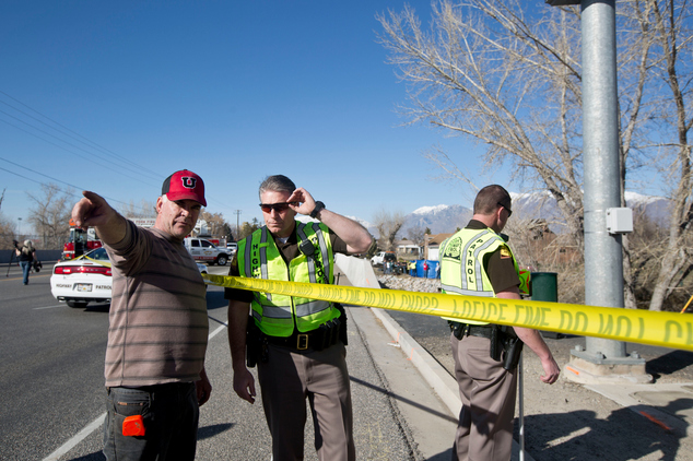 In this March 7, 2015 photo, officials respond to a report of car in the Spanish Fork River near the Main Street and the Arrowhead Trail Road junction in Spanish Fork, Utah. An 18-month-old girl survived a car crash in a frigid Utah river after being strapped in a car seat upside-down for some 14 hours before being found by a fisherman, but her 25-year-old mother, Lynn Groesbeck, of Springville, was found dead in the car, police said Sunday. (AP Photo/The Daily Herald, Sammy Jo Hester)