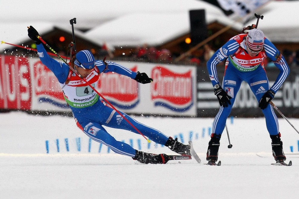 RUHPOLDING, GERMANY - JANUARY 17:  Anton Shipulin (L) of Russia crashes during the handover by his team mate Ivan Tcherezov (R) during the Men's 4 x 7,5km Relay in the e.on Ruhrgas IBU Biathlon World Cup on January 17, 2010 in Ruhpolding, Germany.  (Photo by Alexander Hassenstein/Bongarts/Getty Images)