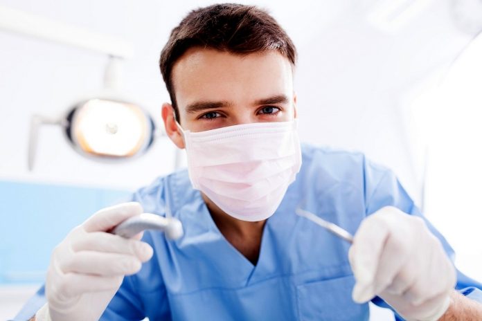 Dentist Holding Dental Tools