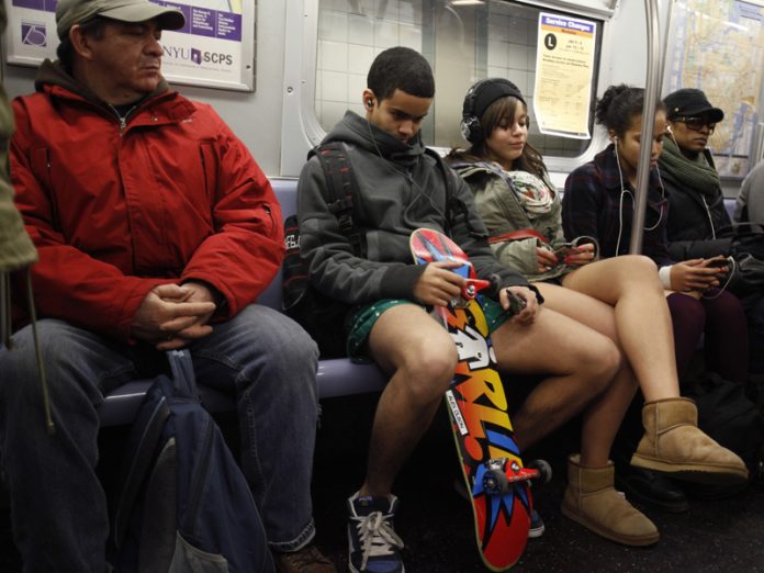 A man looks at participants of the 9th Annual No Pants Subway Ride in New York City