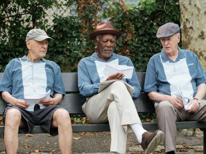 Michael-Caine-Morgan-Freeman-and-Alan-Arkin-sit-on-a-park-bench-for-Going-in-Style