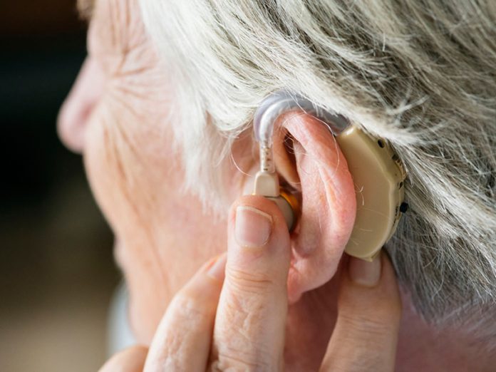 Elderly woman wearing a hearing aid
