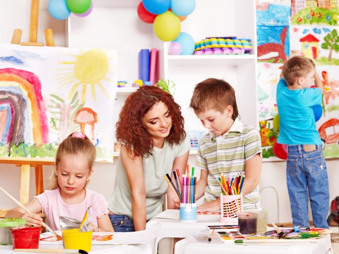 Child painting at easel.